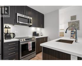 A modern kitchen with dark wood cabinets and white countertops.