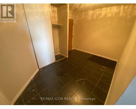 A room with black tiled flooring and white walls.