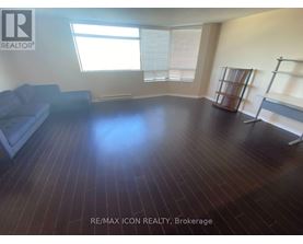 A room with wooden flooring and a couch.