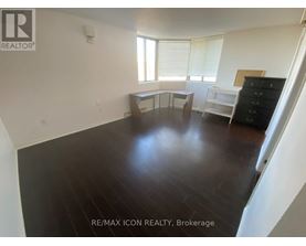 A room with a wooden floor and white walls.