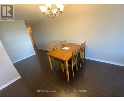 A dining room with a wooden table and chairs.