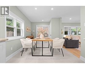 A dining room with a table and chairs.