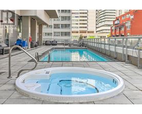 A hot tub on a balcony with a city view.