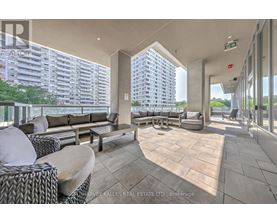 A spacious outdoor seating area with a view of a high-rise building.