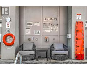 A wall with a sign that says shallow area.