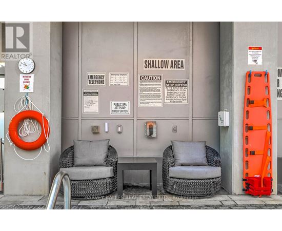 A wall with a sign that says shallow area.