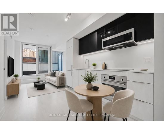 A modern kitchen with a dining table and chairs.