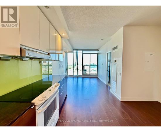 A kitchen with a stove top oven and a window.