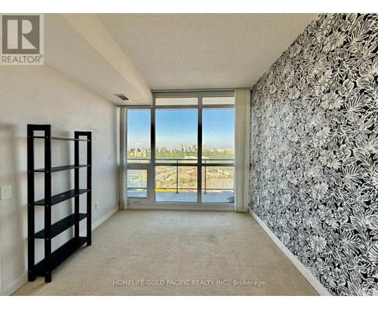 A room with a view of the city through the window.
