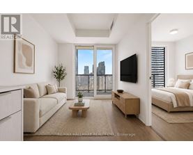 A living room with a large window overlooking a city skyline.