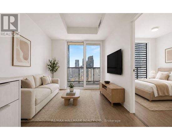 A living room with a large window overlooking a city skyline.