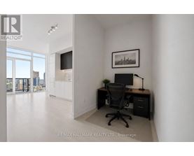 A room with a desk and a chair in it.
