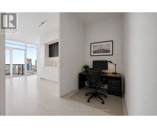 A room with a desk and a chair in it.