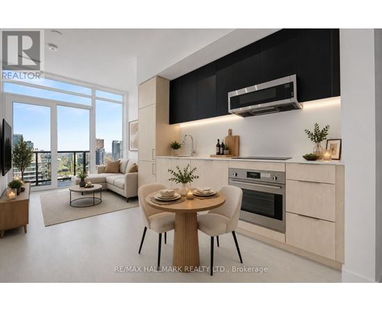 A modern kitchen with a dining table set for two.