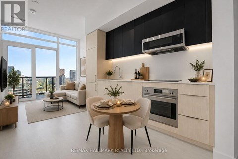A modern kitchen with a dining table set for two.