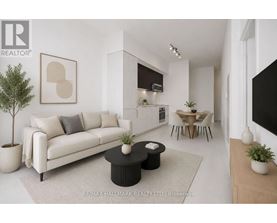 A modern living room with a white sofa, a black coffee table, and a dining area in the background.
