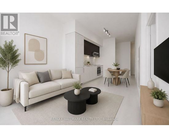 A modern living room with a white sofa, a black coffee table, and a dining area in the background.