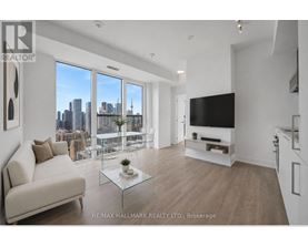 A modern living room with a view of the city skyline.