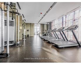 A gym with treadmills and a row of exercise machines.