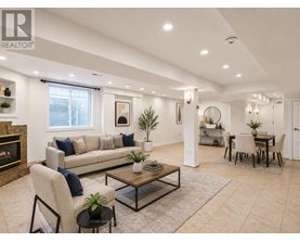 A living room with a fireplace, a sofa, a coffee table, and a dining table.