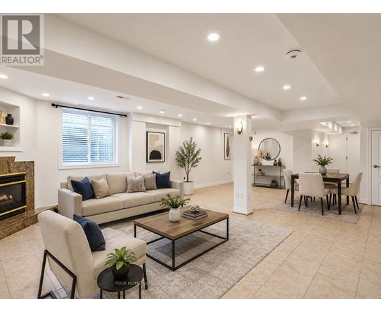 A living room with a fireplace, a sofa, a coffee table, and a dining table.