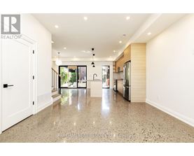 A spacious kitchen with granite countertops and a view of the backyard.