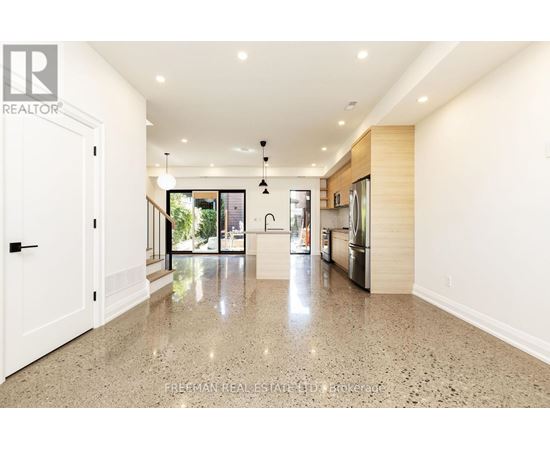 A spacious kitchen with granite countertops and a view of the backyard.