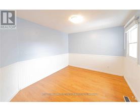 A room with wooden flooring and a window.