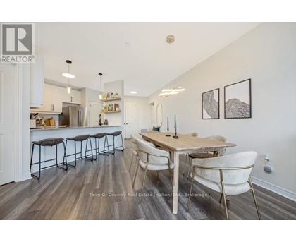 A dining room with a wooden table and chairs.