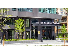 The building at 110-120 Broadway Avenue is a modern structure with a glass facade.