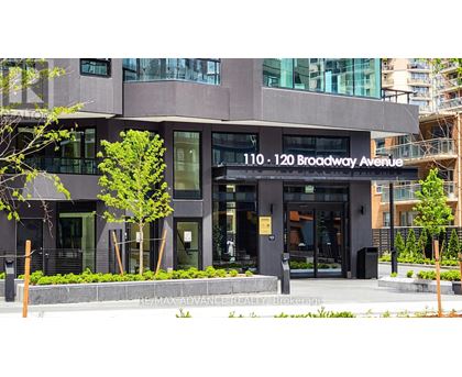 The building at 110-120 Broadway Avenue is a modern structure with a glass facade.
