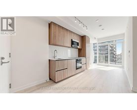 A modern kitchen with wooden cabinets and appliances.