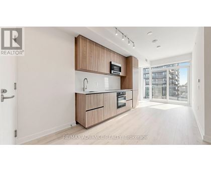 A modern kitchen with wooden cabinets and appliances.