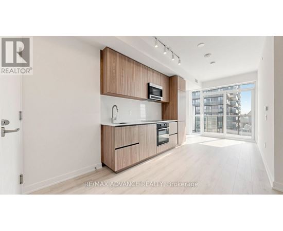 A modern kitchen with wooden cabinets and appliances.