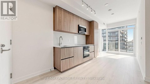 A modern kitchen with wooden cabinets and appliances.