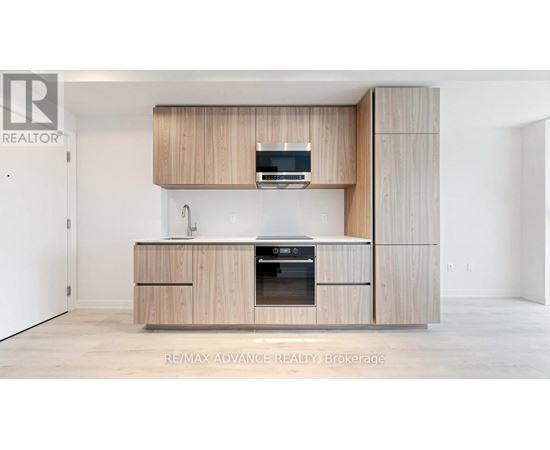 A modern kitchen with wooden cabinets and appliances.