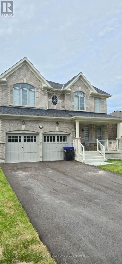 A two-story house with a driveway in front.