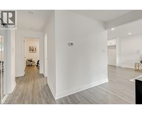 A spacious room with a wooden floor and white walls.