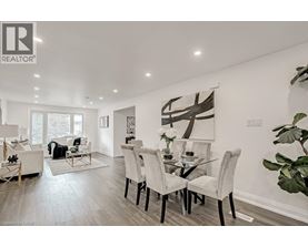 A modern dining room with a glass table and chairs.