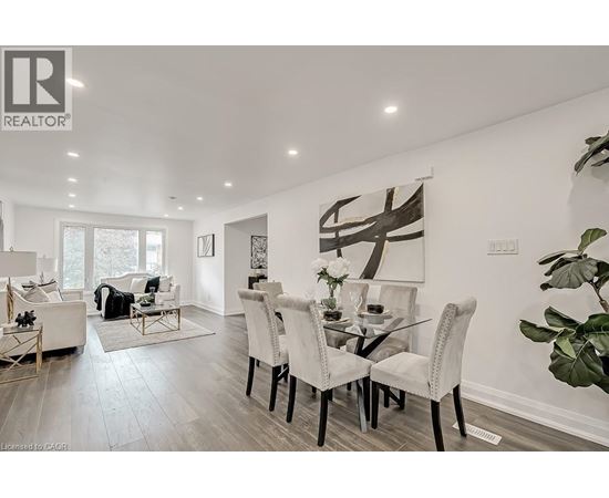 A modern dining room with a glass table and chairs.