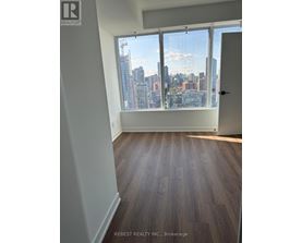 A room with a view of a city skyline through the window.