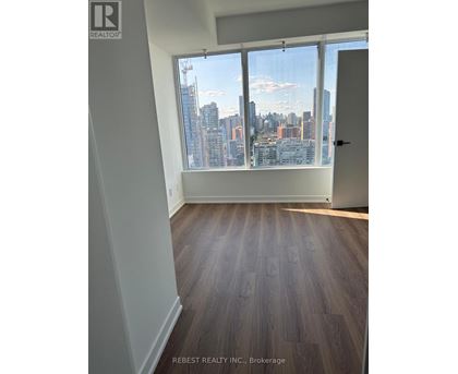A room with a view of a city skyline through the window.