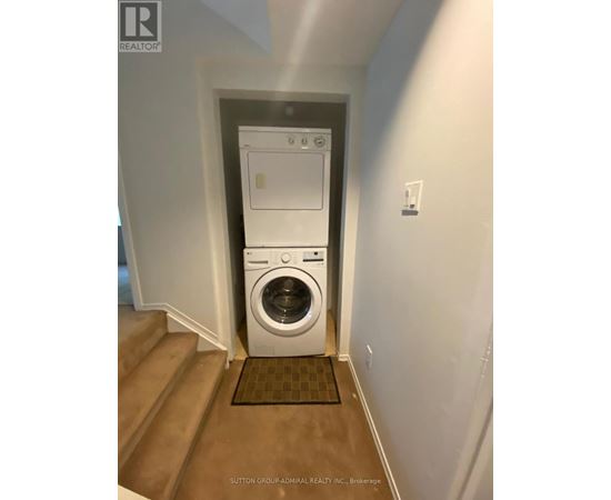 A white washer and dryer in a small room.