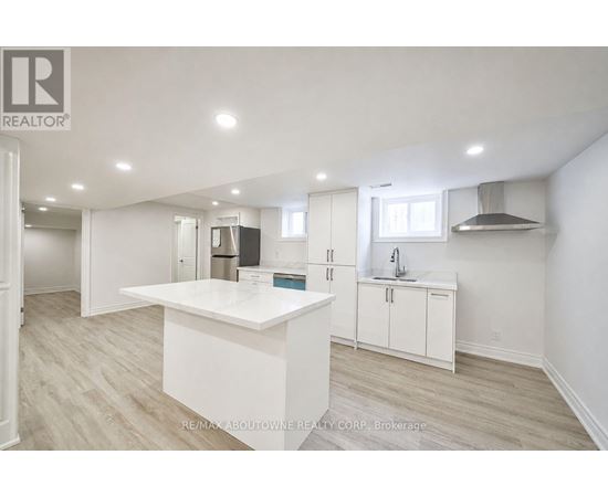 A white kitchen with a large island in the middle.