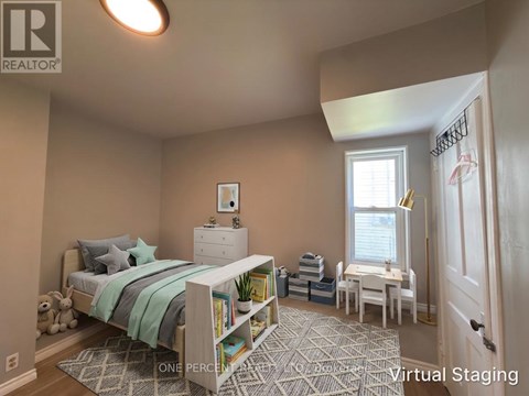 A bedroom with a bed, nightstand, and chair.
