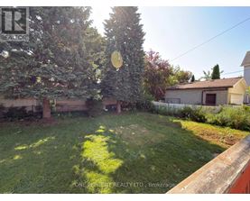 A backyard with a lawn and trees.