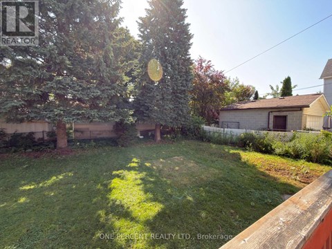 A backyard with a lawn and trees.