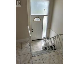 A white door with a glass window is in a hallway.