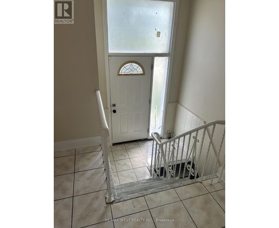 A white door with a glass window is in a hallway.