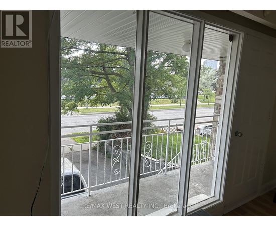 A view from inside a room looking out through a sliding glass door.